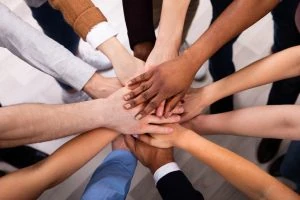 team members stacking their hands together.