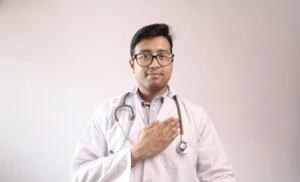 male indian doctor in white coat and stethoscope swearing hippocratic oath