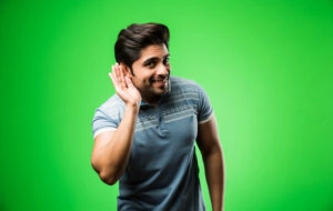 Man Listening holding his hand near his ear