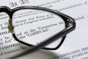 pair of glasses on a printed copy of the CARES Act