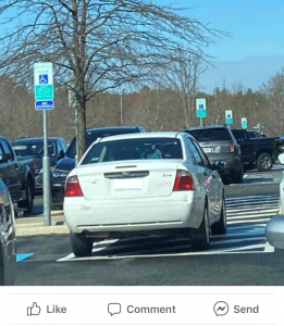 car parked on handicap space hashmarks