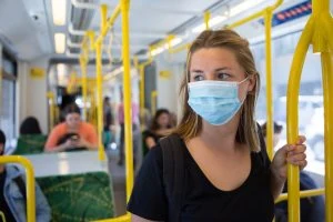 Woman wearing a mask on a bus