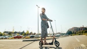 Young woman on an electric scooter