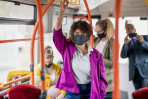 passengers on a bus wearing protective masks during the Covid 19 pandemic.