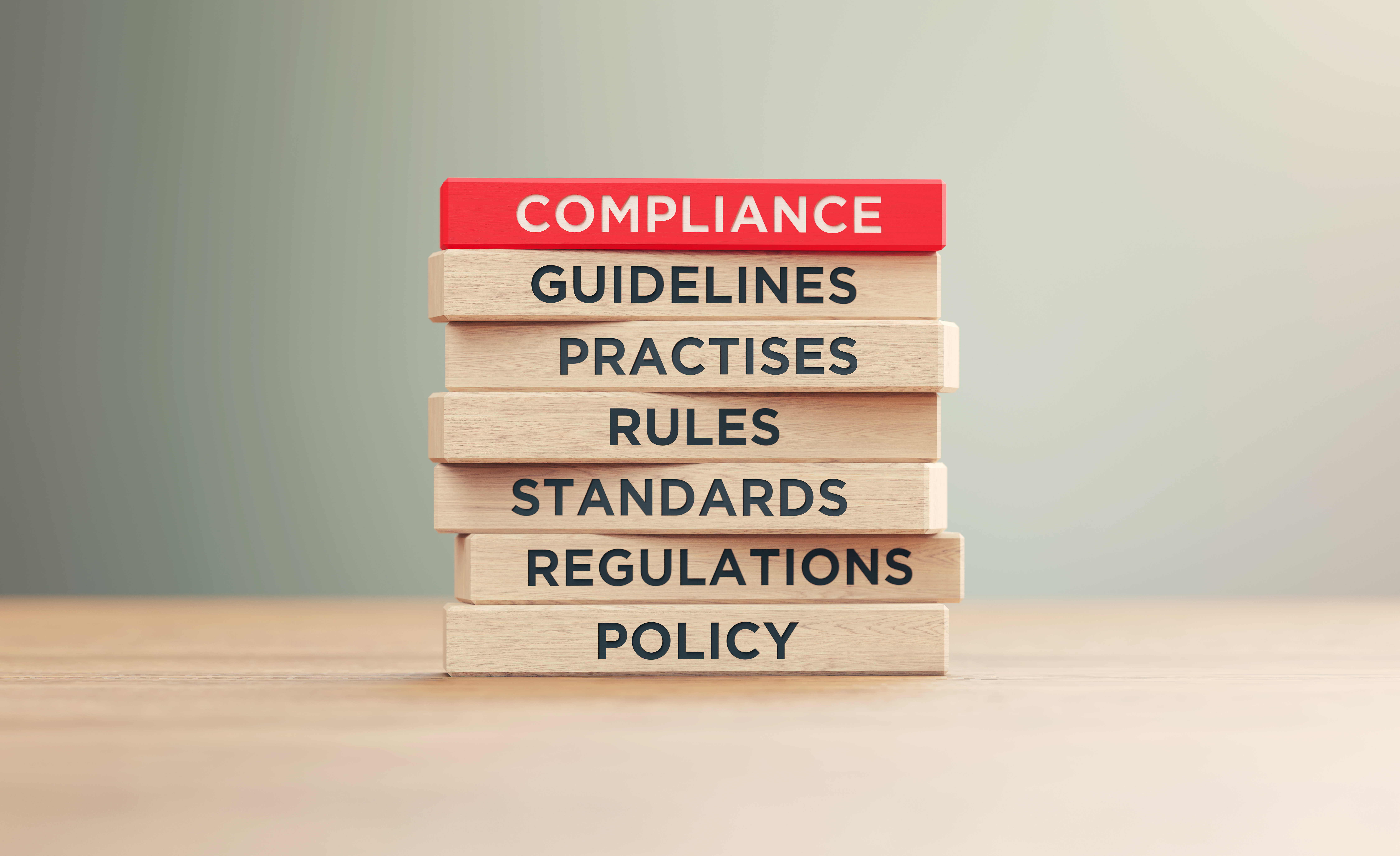 Compliance Related Words Written Wood Blocks Sitting on Wood Surface.