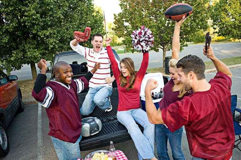 Students tailgating and cheering for their football team