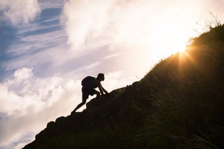 Stock image of person climbing a steep hill