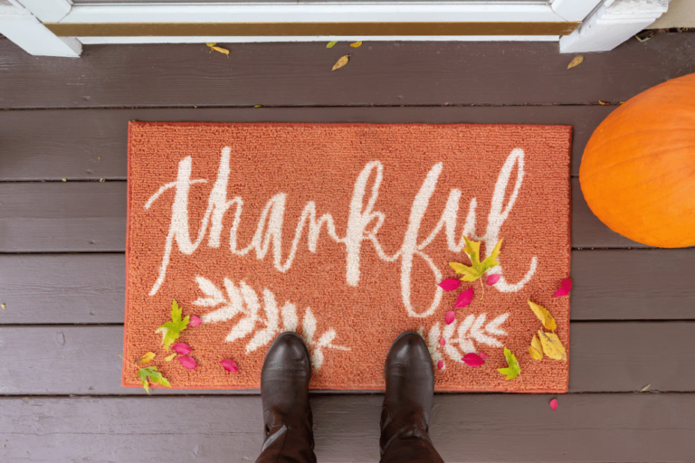 Stock image of a welcome mat saying "Thankful"