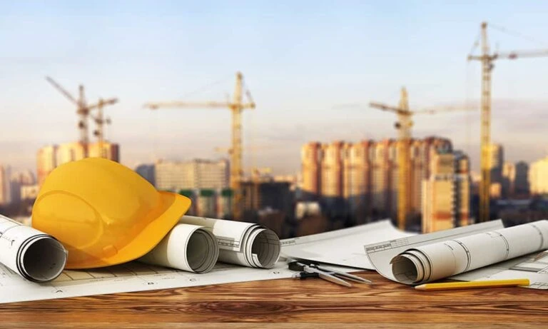 Stock photo of architect's tools near a construction site