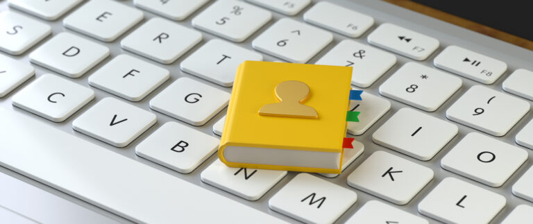 Contact list book on the keyboard of a laptop, for support and customer concepts