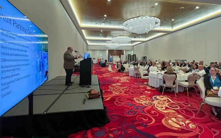 IPMI Seminar, with those in attendance watching from large round tables