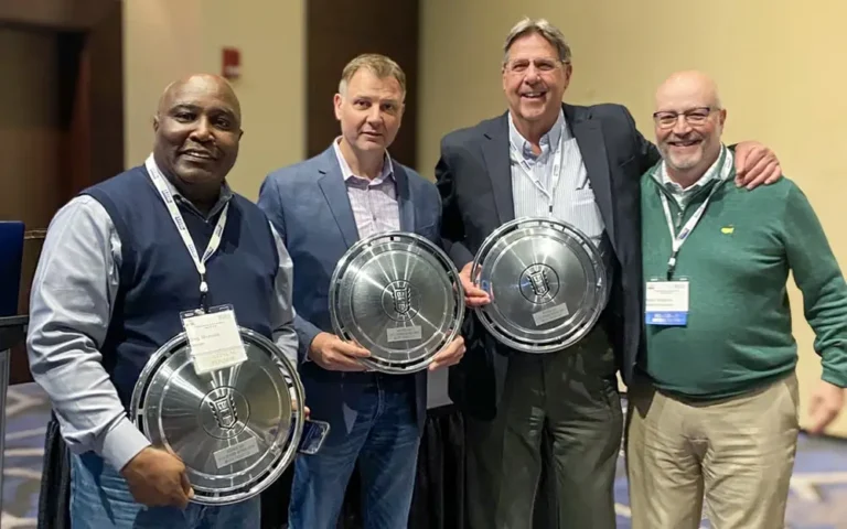Group photo of a group of men holding trophys
