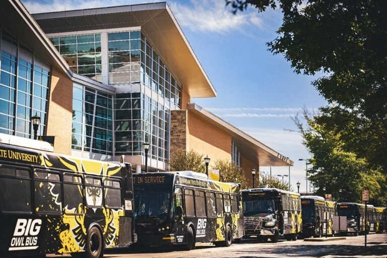 University big owl mascot buses from Kennesaw State lined up waiting for students