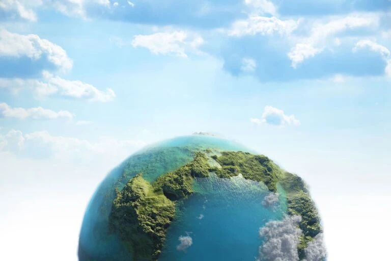 Rendering of green earth and blue seas in a puffy clouds sky
