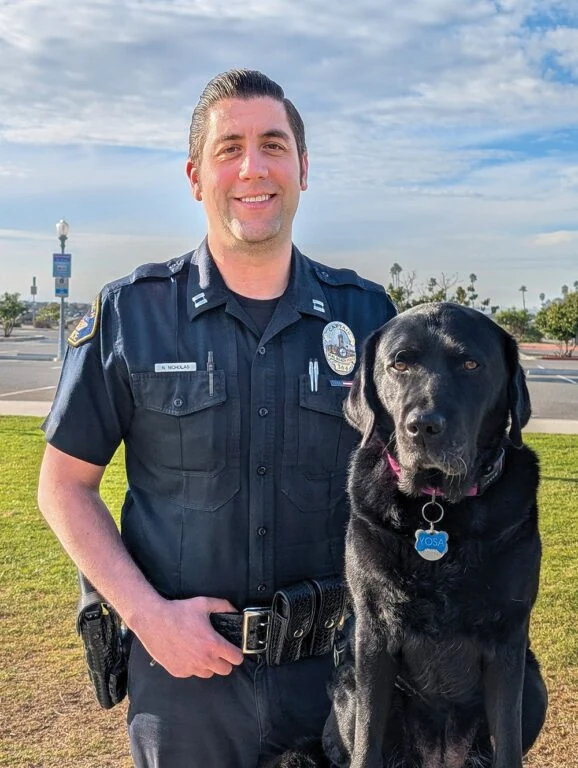 Photo of Police Captain R. Nicholas with police dog Yosa