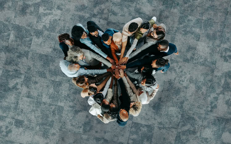 team employees all unified into a shape of a heart formation