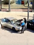 Two veteran Parking Enforcement Officers assisting a family