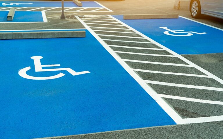 Asphalt car parking lot reserved for handicapped drivers