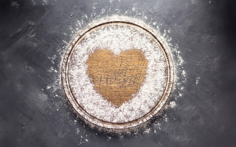 Gen AI image of a gold heart inside a white circle with a gray background