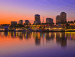 Rainbow Harbor at Long Beach Marina with city skyline at sunset, California