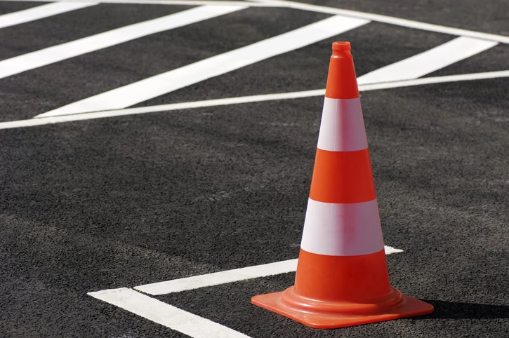 Traffic cone /pylon on a brand-new parking place.