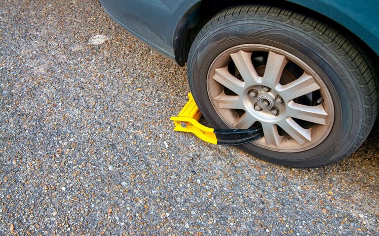Booted tire. Yellow and black boot to prevent car from moving