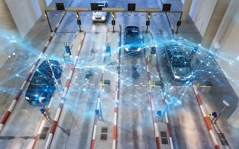 Cars traveling through a toll booth, while an abstract network shows above the cars