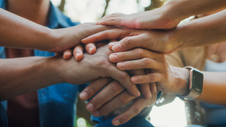 Closeup diverse group of people engaging in supportive group therapy session, sharing personal stories and advice to promote mental health and recovery in park. Mental health community concept.