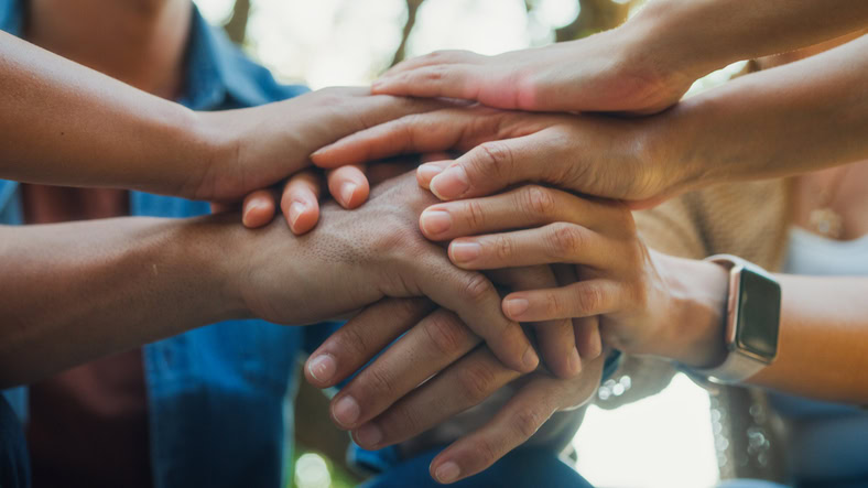 Closeup diverse group of people engaging in supportive group therapy session, sharing personal stories and advice to promote mental health and recovery in park. Mental health community concept.