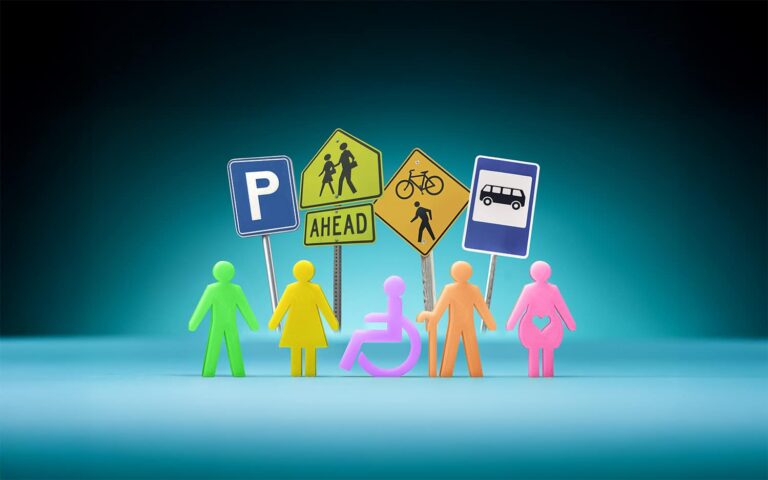 Colorful plastic silhouettes in front of common street signs