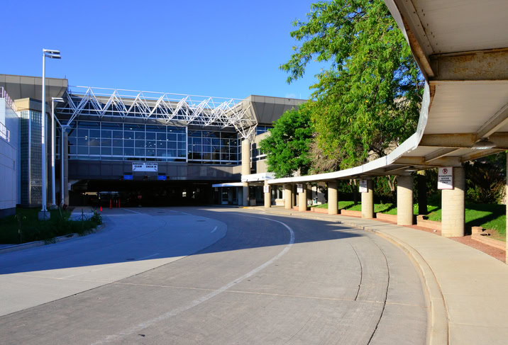 Milwaukee, Wisconsin, USA: General Mitchell International Airport - terminal building, land-side road and sidewalk access - The airport is named after United States Army General Billy Mitchell, the father of the United States Air Force.