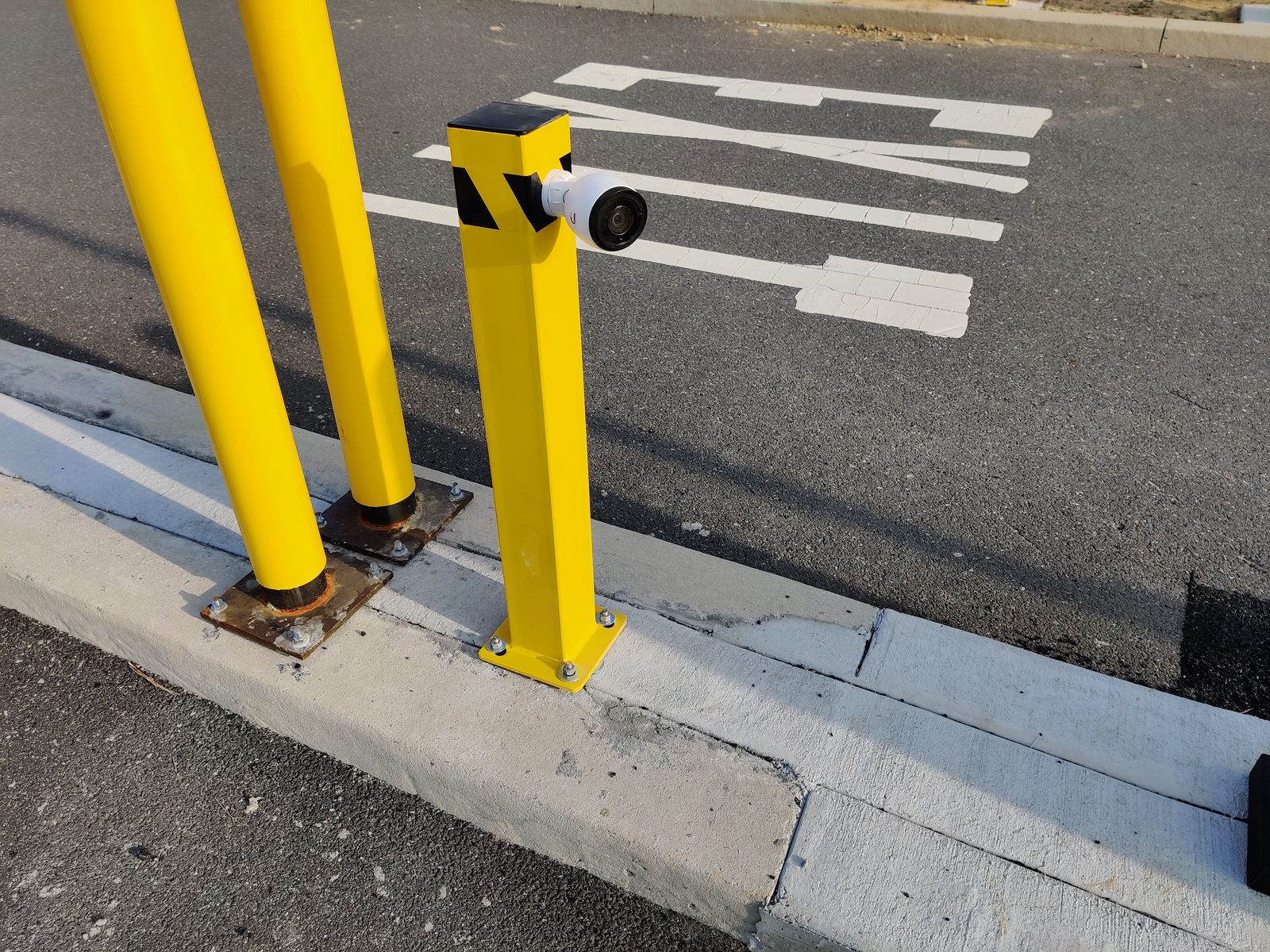 ALPR bollard camera mounted at a parking lot entrance for automated license plate recognition